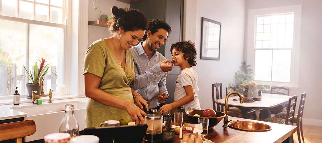 Latino Family preparing food in airy kitchen